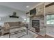 Charming living room features a stone fireplace and sun-lit windows at 1014 Massey Ct, Greenwood, IN 46143