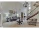Open-concept living room with elegant chandelier, fireplace, and staircase at 1014 Massey Ct, Greenwood, IN 46143