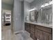 Dual sinks, wood cabinets, and a doorway to the walk-in closet are featured in this bathroom at 1014 Massey Ct, Greenwood, IN 46143