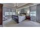 Spacious main bedroom with large windows, trey ceiling, chandelier, and neutral decor at 1014 Massey Ct, Greenwood, IN 46143