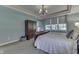 Main bedroom showcasing a trey ceiling, plush carpeting, natural light, and stylish furniture at 1014 Massey Ct, Greenwood, IN 46143