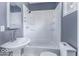 This is a bathroom with a shower-tub combo, single sink, and window for natural light at 1049 N Tremont N St, Indianapolis, IN 46222