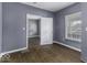 This bedroom features an open doorway, hardwood floors, a window, and neutral walls at 1049 N Tremont N St, Indianapolis, IN 46222