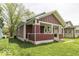 Quaint one-story home with a covered front porch, classic architectural details, and a lush green lawn at 1049 N Tremont N St, Indianapolis, IN 46222