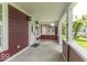 Welcoming covered front porch featuring classic columns, outdoor lighting, and a charming entrance door at 1049 N Tremont N St, Indianapolis, IN 46222