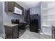 Compact kitchen features stainless steel appliances, neutral countertops, and tile flooring at 1049 N Tremont N St, Indianapolis, IN 46222