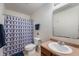 Standard bathroom features a toilet, vanity, sink, mirror, and blue patterned shower curtain at 10625 Gathering Dr, Indianapolis, IN 46259