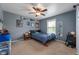 Bedroom with blue walls, carpeted floor, ceiling fan, and a window at 10625 Gathering Dr, Indianapolis, IN 46259