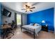 Bedroom with blue accent wall, carpeted floor, ceiling fan, and a desk at 10625 Gathering Dr, Indianapolis, IN 46259