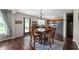 Open-concept dining area with dark wood floors, a stylish chandelier, and direct access to the kitchen at 10625 Gathering Dr, Indianapolis, IN 46259