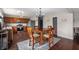Charming dining area featuring hardwood floors, open layout, and stainless steel appliances in the adjacent kitchen at 10625 Gathering Dr, Indianapolis, IN 46259