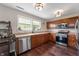 Well-lit kitchen featuring wood cabinets, stainless steel appliances and a dual window over the sink at 10625 Gathering Dr, Indianapolis, IN 46259