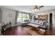 Cozy living room with hardwood floors, a comfortable grey sofa, and open access to the dining area at 10625 Gathering Dr, Indianapolis, IN 46259