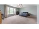 Large main bedroom with neutral carpet, ceiling fan, and a bank of windows providing natural light at 10625 Gathering Dr, Indianapolis, IN 46259