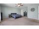 Spacious main bedroom with large carpeted floor, ceiling fan, and neutral walls at 10625 Gathering Dr, Indianapolis, IN 46259
