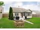 Lush backyard with a fire pit, patio, and green space at 11108 Oakridge Dr, Fishers, IN 46038