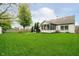 Expansive green backyard featuring a fire pit and partial fence at 11108 Oakridge Dr, Fishers, IN 46038