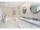Bright bathroom featuring double sinks, a tub, and white tile flooring at 11108 Oakridge Dr, Fishers, IN 46038