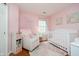 Charming Bedroom decorated in pink with a crib and comfortable rocking chair at 11108 Oakridge Dr, Fishers, IN 46038
