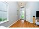 Bright and airy home foyer with hardwood floors, a large window, and a modern light fixture at 11108 Oakridge Dr, Fishers, IN 46038