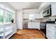 Modern kitchen with white cabinets, stainless steel appliances, and plenty of natural light at 11108 Oakridge Dr, Fishers, IN 46038