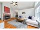 Spacious living room with hardwood floors, a brick fireplace, and a comfortable sectional sofa at 11108 Oakridge Dr, Fishers, IN 46038
