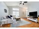 Open-concept living area with vaulted ceilings, hardwood floors, and a comfortable seating arrangement at 11108 Oakridge Dr, Fishers, IN 46038