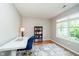 Bright office space with a desk, bookshelf, and large window at 11108 Oakridge Dr, Fishers, IN 46038