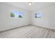 A bright bedroom with two windows and hardwood style flooring at 1116 Heatherwood Dr, Indianapolis, IN 46241