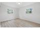 Bedroom with hardwood flooring and bright windows offering outdoor views at 1116 Heatherwood Dr, Indianapolis, IN 46241