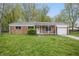 Charming brick ranch home with a one car garage and a well maintained lawn and landscaping at 1116 Heatherwood Dr, Indianapolis, IN 46241