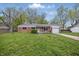 Charming brick ranch home with a one car garage and a well maintained lawn and landscaping at 1116 Heatherwood Dr, Indianapolis, IN 46241