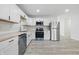 Modern kitchen with stainless steel appliances, white cabinets and hardwood countertops at 1116 Heatherwood Dr, Indianapolis, IN 46241