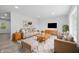 Bright living room with neutral decor, with a cozy sofa, chairs, rug, coffee table and a large window at 1116 Heatherwood Dr, Indianapolis, IN 46241