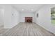 Cozy living room with a brick fireplace and a window for natural light at 1116 Heatherwood Dr, Indianapolis, IN 46241