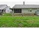 Rear of the house showing screened porch and portion of the backyard at 11541 Coastal Dr, Indianapolis, IN 46229
