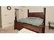 Bedroom featuring a wooden bed frame, neutral carpet, and an attached bathroom, providing comfort and convenience at 11541 Coastal Dr, Indianapolis, IN 46229