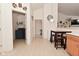 Hallway that has a small dining area with a table and view of laundry room at 11541 Coastal Dr, Indianapolis, IN 46229