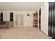 An open living room with curtains, a chandelier, and French doors leading outside at 11541 Coastal Dr, Indianapolis, IN 46229