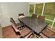 Inviting screened porch with outdoor dining set and views of the lush surrounding greenery at 11541 Coastal Dr, Indianapolis, IN 46229