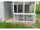 Exterior view of a screened porch with a white railing and lawn at 11541 Coastal Dr, Indianapolis, IN 46229