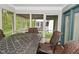 Charming screened porch with outdoor dining set and serene backyard views at 11541 Coastal Dr, Indianapolis, IN 46229