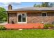 A brick house has a deck and manicured landscaping in backyard at 1171 S Daisy Ln, New Palestine, IN 46163