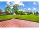 A spacious, well-maintained backyard features a stained wood deck at 1171 S Daisy Ln, New Palestine, IN 46163