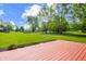 A spacious, well-maintained backyard features a stained wood deck at 1171 S Daisy Ln, New Palestine, IN 46163