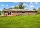 A well-maintained brick house with large backyard and red deck at 1171 S Daisy Ln, New Palestine, IN 46163