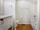 Bathroom featuring a vanity with a sink, mirror, toilet, and shower/tub combo with wood look flooring at 1171 S Daisy Ln, New Palestine, IN 46163