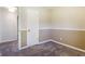 A bedroom boasts neutral walls, soft carpeting, and a classic white door at 1171 S Daisy Ln, New Palestine, IN 46163