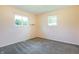 Cozy bedroom featuring two windows, plush carpet, and neutral walls, creating a warm and inviting atmosphere at 1171 S Daisy Ln, New Palestine, IN 46163