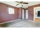 Bedroom featuring neutral carpeting, two windows that provide natural light, and brown color painted walls at 1171 S Daisy Ln, New Palestine, IN 46163